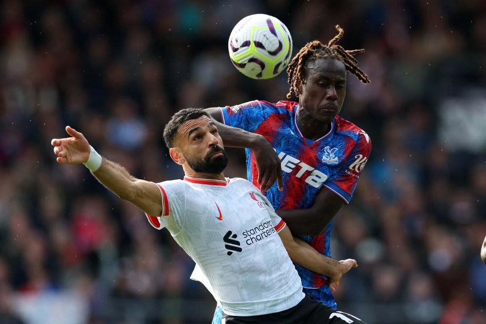 Photograph of two soccer players vying for the ball.