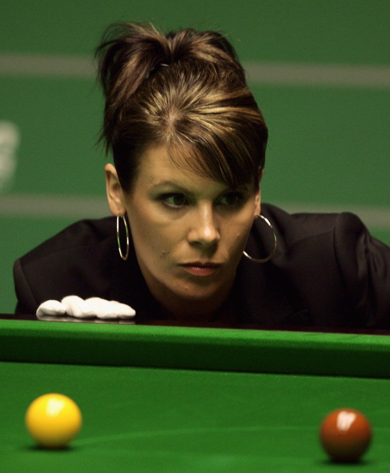 Referee Michaela Tabb watches snooker balls during a match.