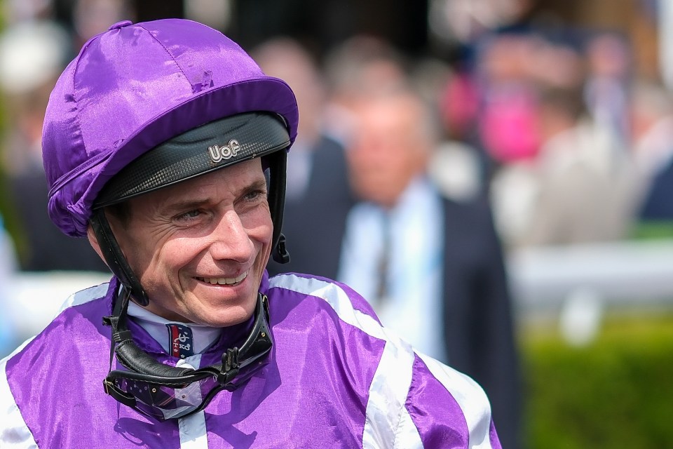 Jockey Ryan Moore smiling after a horse race win.