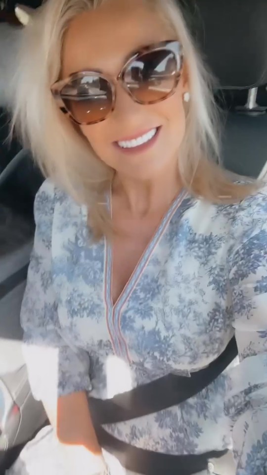 Screenshot of a woman in a car showing off her new teeth.