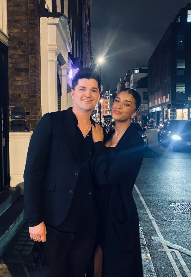 Danny O’Donoghue and his fiancée, Anais Naing, posing for a photo at night.
