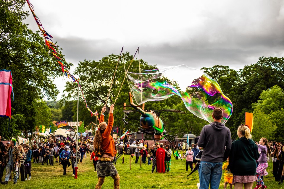 Person making a giant bubble at the Shindig Festival.