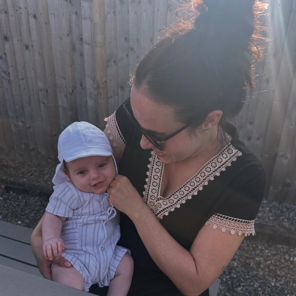 A mother holding her baby son.