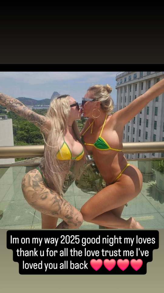 Two women kissing on a balcony.