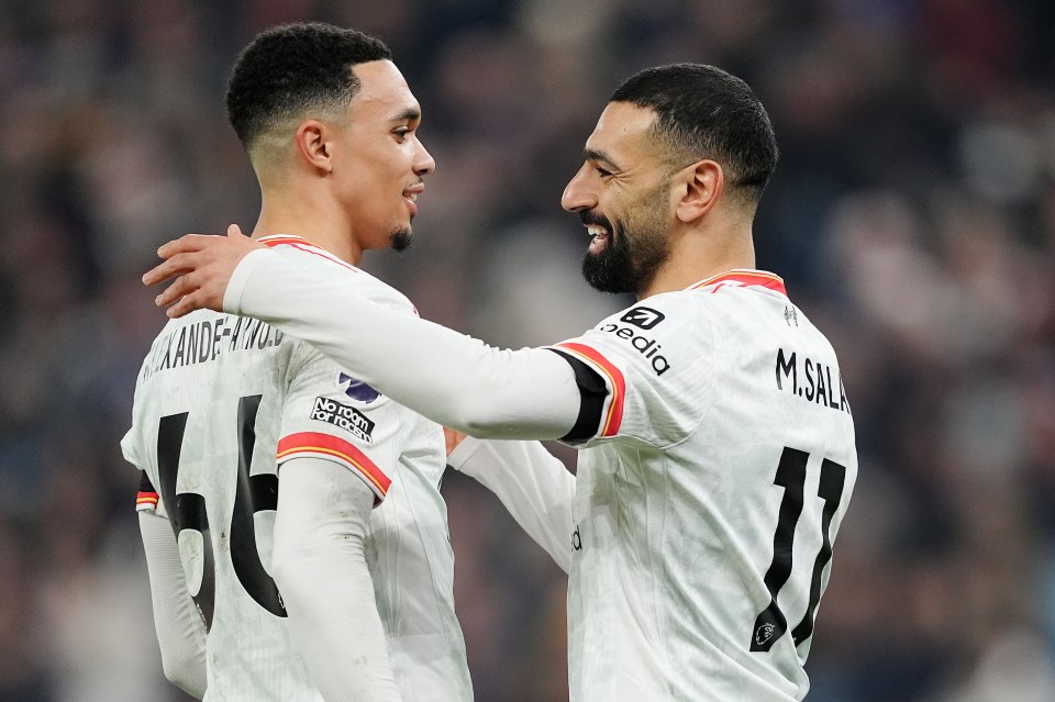 Mohamed Salah and Trent Alexander-Arnold embracing.