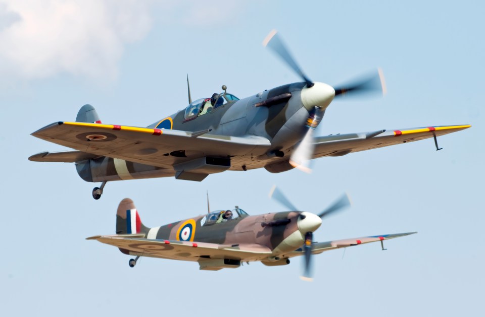 Two Supermarine Spitfire fighter planes in flight.