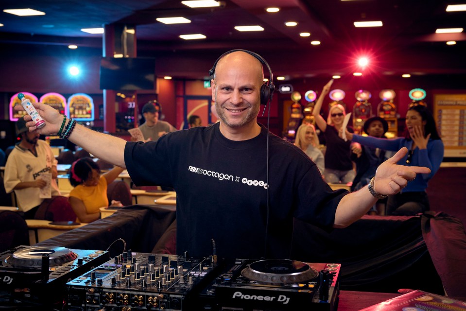 DJ at a bingo hall with a crowd celebrating.
