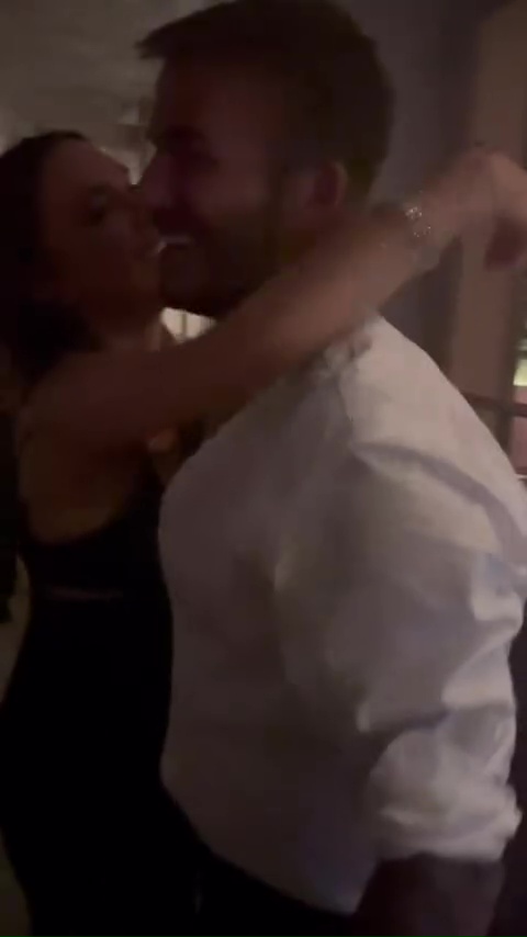 Victoria and David Beckham embracing.