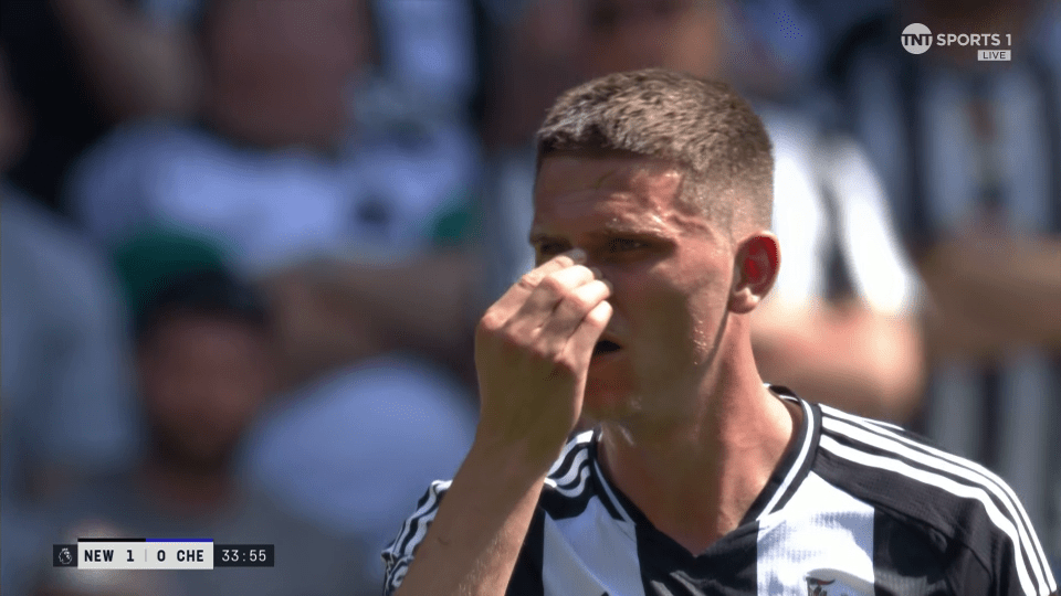 Close-up of a soccer player wiping his nose.