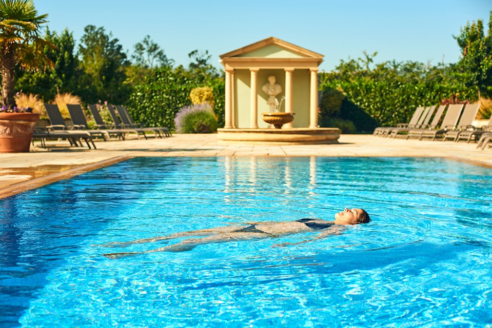 Woman floating in a resort pool.