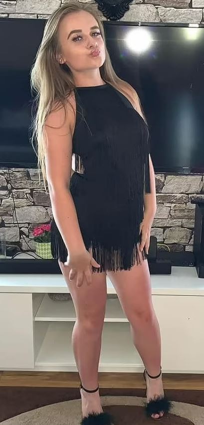 A young woman in a black fringed dress.