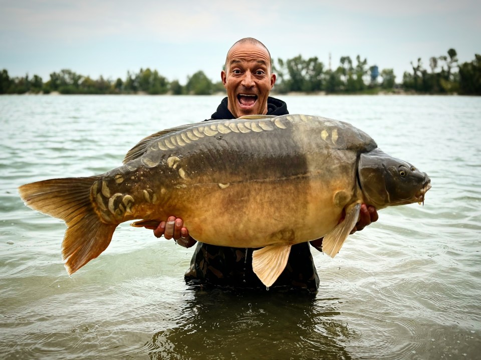 Man holding a large carp.