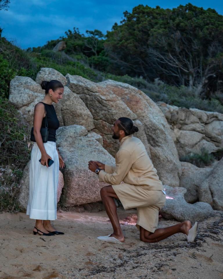 Man proposing to woman on a beach.