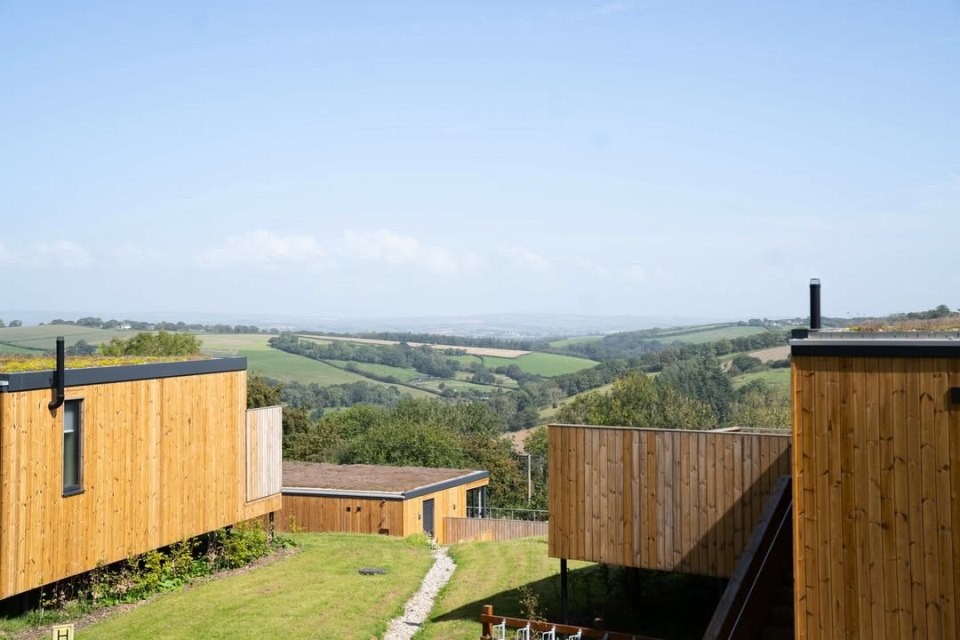 Wooden cabins overlooking a valley.