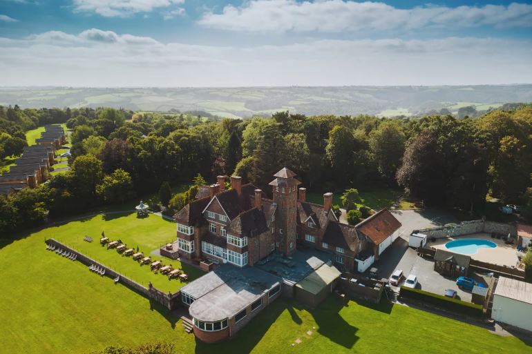 Aerial view of Mole Resort in Devon, showing the main building, surrounding grounds, and lodging.