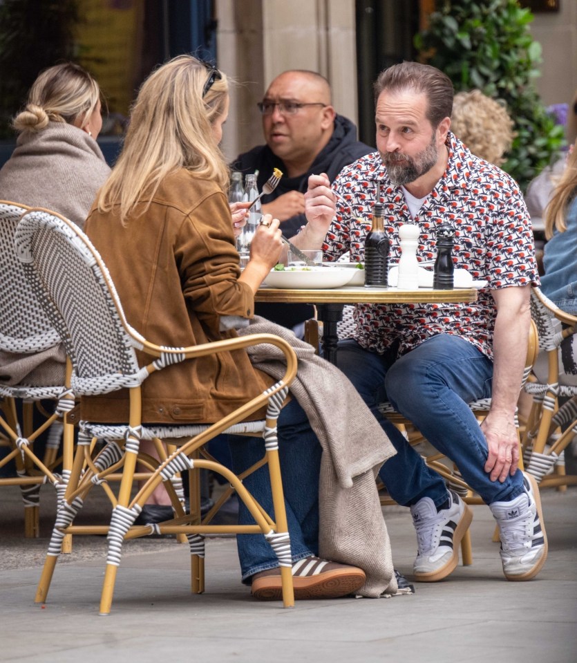 Alfie Boe and his girlfriend having lunch at an outdoor restaurant.