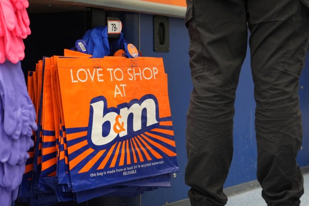 Stack of orange B&M shopping bags.