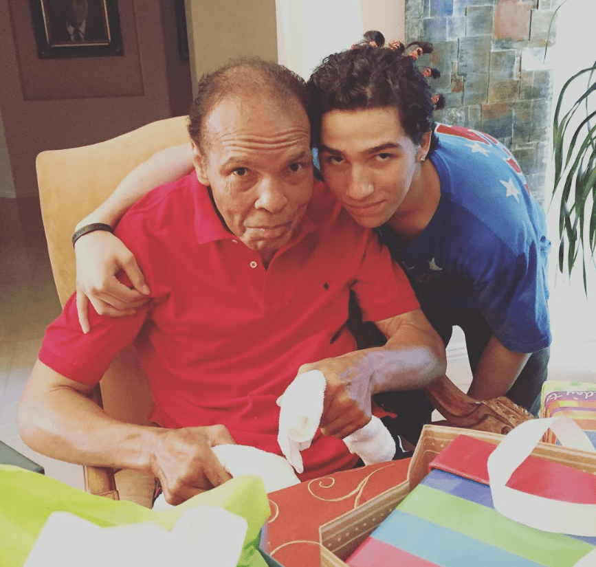Muhammad Ali with his arm around a younger man.