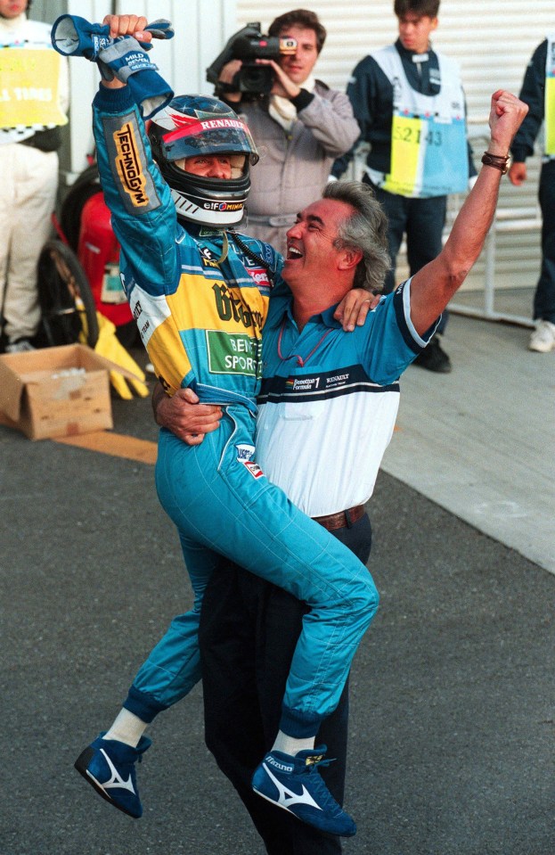 Michael Schumacher being hoisted in celebration by Flavio Briatore.