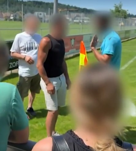 People arguing on a soccer field.