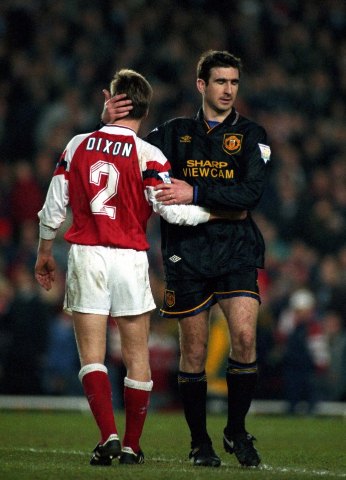 Lee Dixon of Arsenal embraces Eric Cantona of Manchester United after Cantona's ejection from a match.