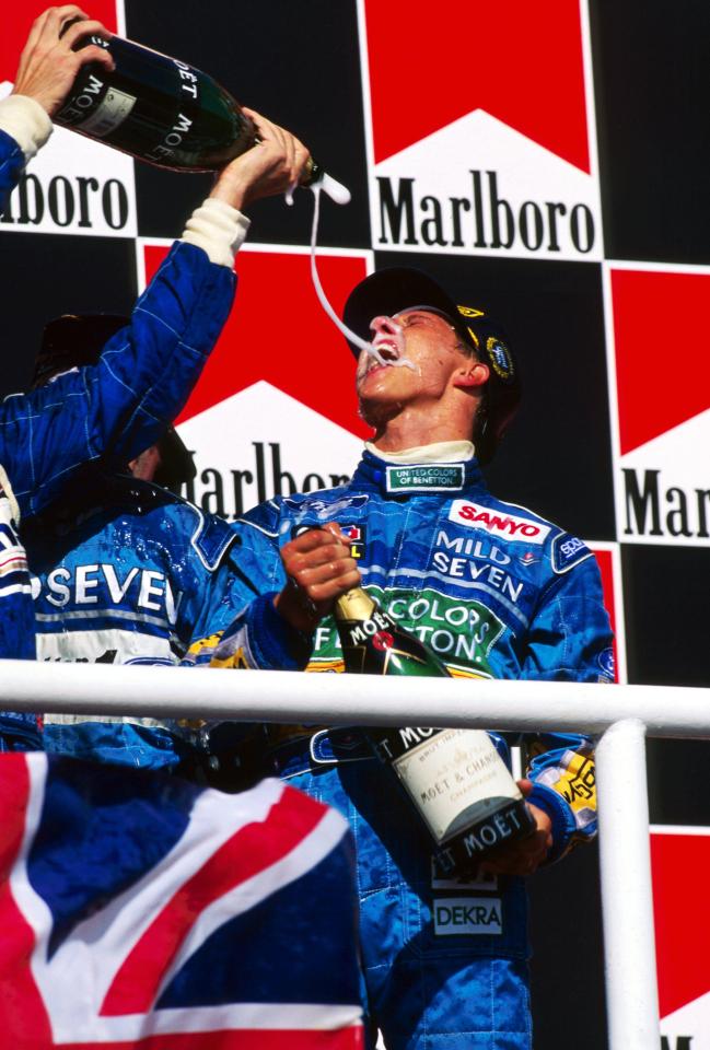 Michael Schumacher spraying champagne on the podium.