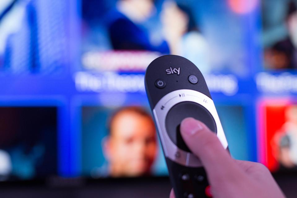 Hand holding Sky Q remote.