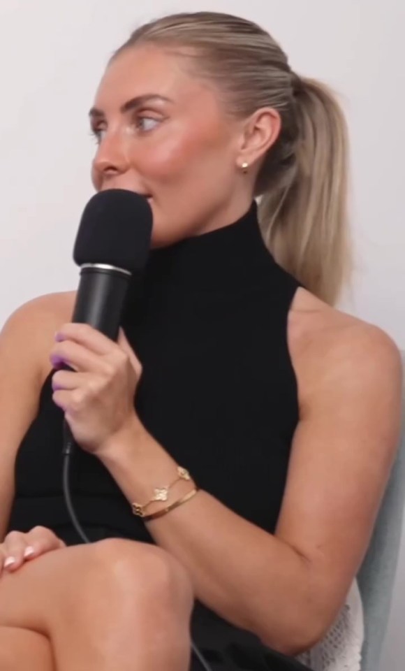 Woman speaking into a microphone.