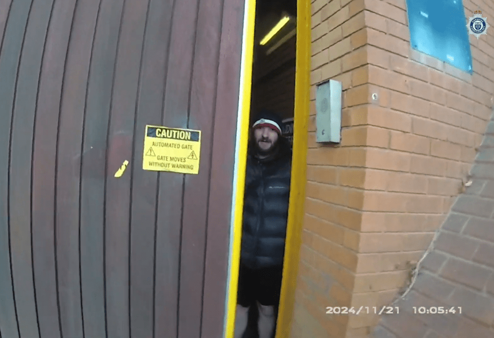 Man standing in doorway of automated gate.