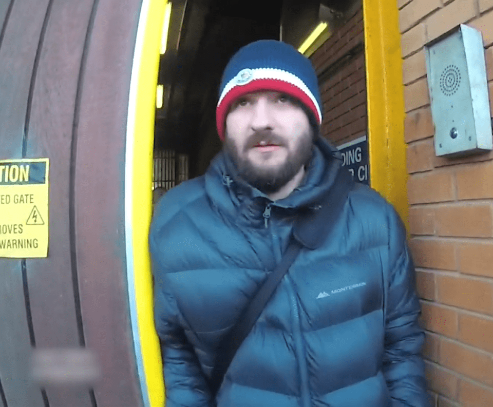 Man in a puffer jacket standing in a doorway.