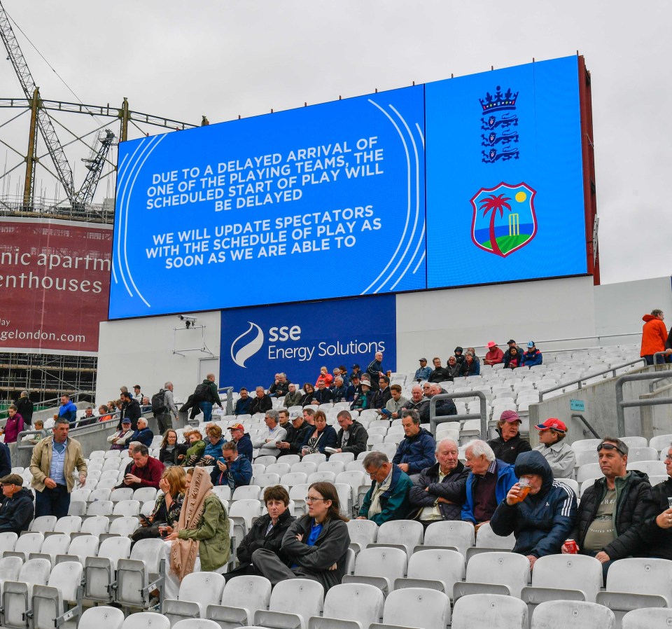 Large screen displaying a delay announcement for a cricket match.