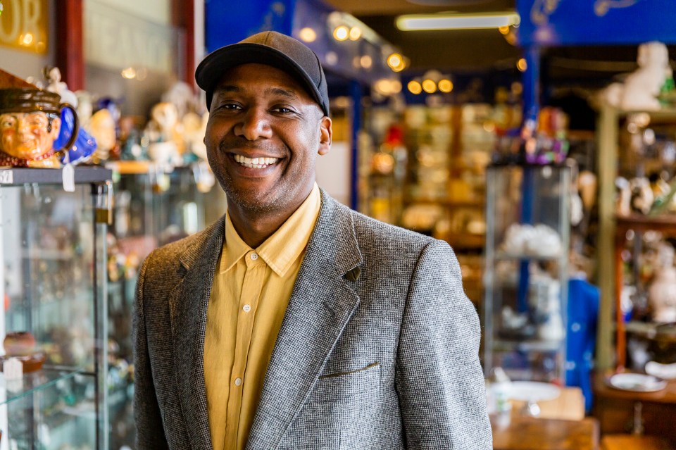 Ochuko Ojiri, BBC presenter, smiling in an antique shop.