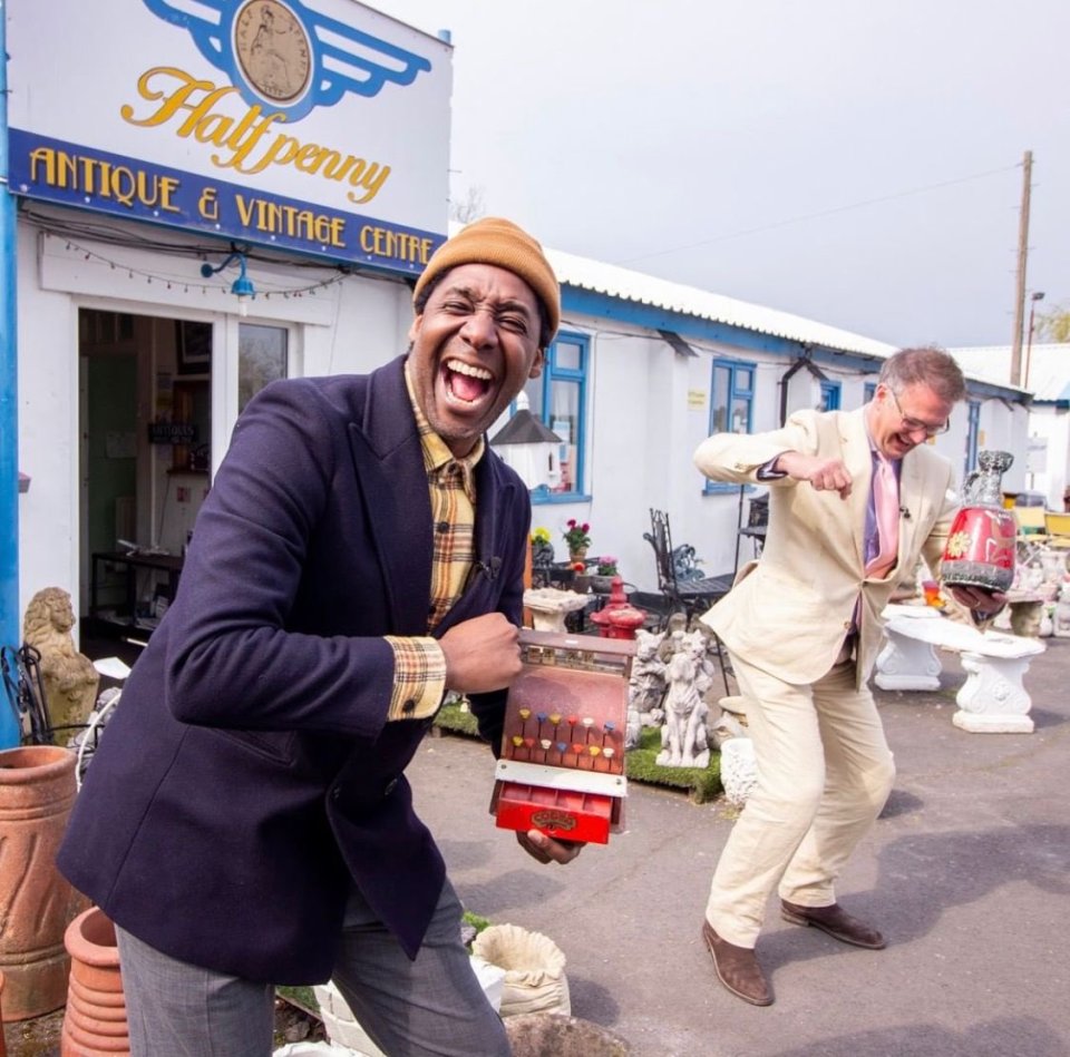 Ochuko Ojiri and another man outside an antique shop.