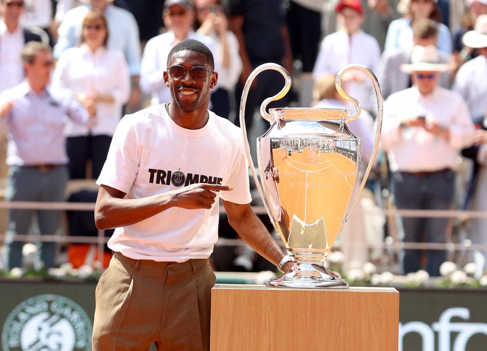 Ousmane Dembélé holding the Champions League trophy at Roland Garros.