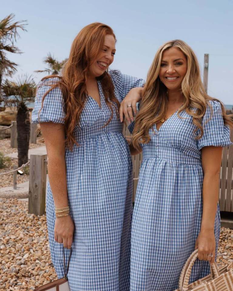 Two women in blue gingham dresses.