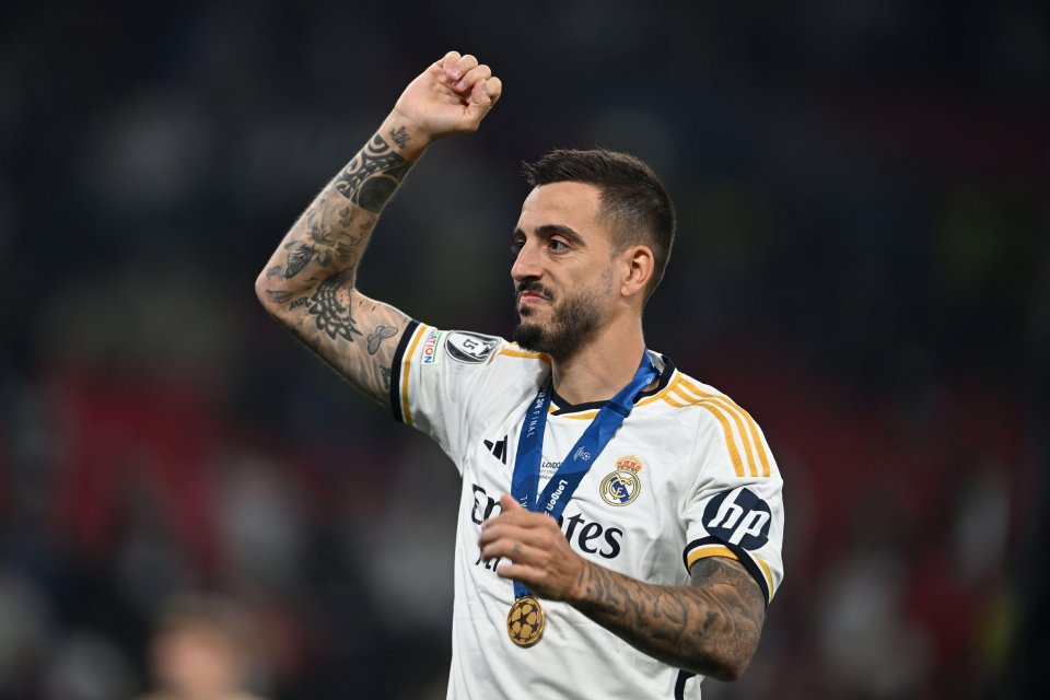 Joselu Sanmartin Mato of Real Madrid celebrating with a medal.