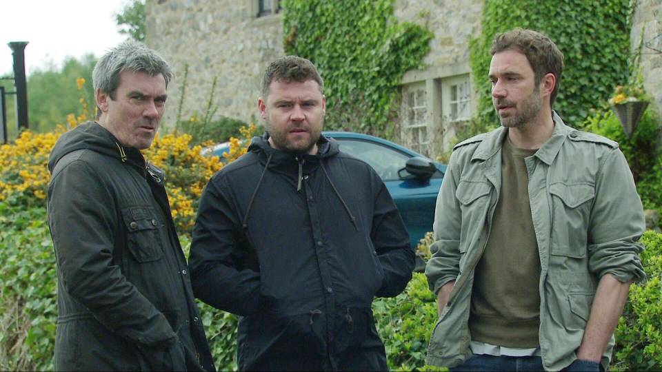 Three men standing outside, discussing Nate's death.
