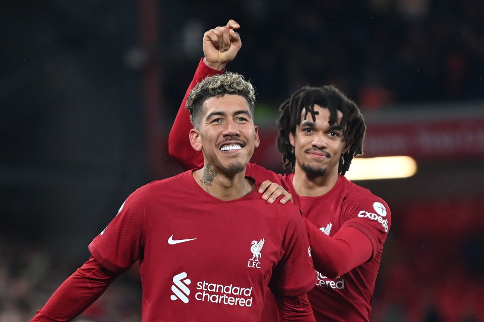 Roberto Firmino and Trent Alexander-Arnold of Liverpool celebrating a goal.