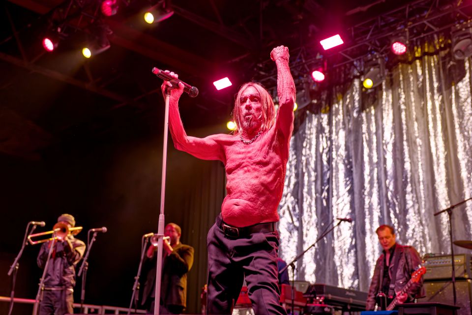 Iggy Pop performing on stage.