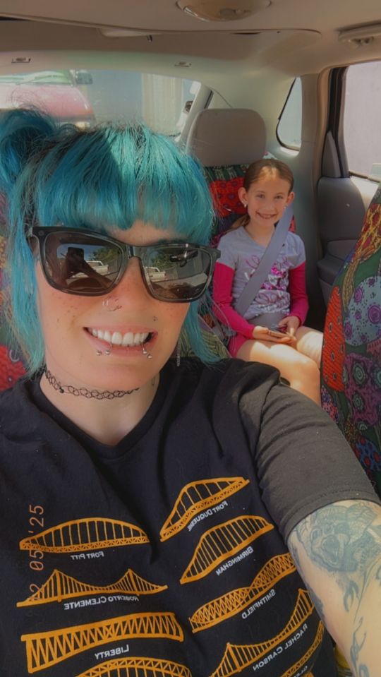 A woman and a girl in a car.