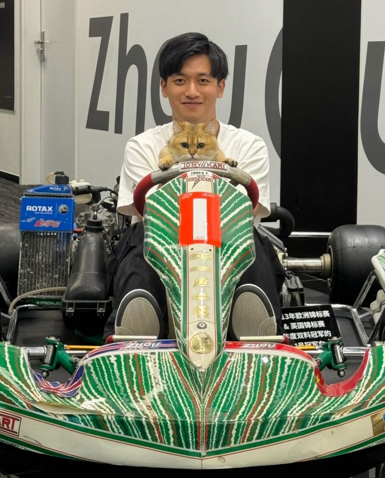 Zhou Guanyu and his cat in a go-kart.