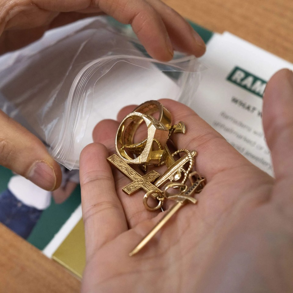 Hand holding scrap gold jewelry.